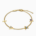 18 karat Gold bracelet with “I am greater than my highs and lows” charms and three different blue gemstones.