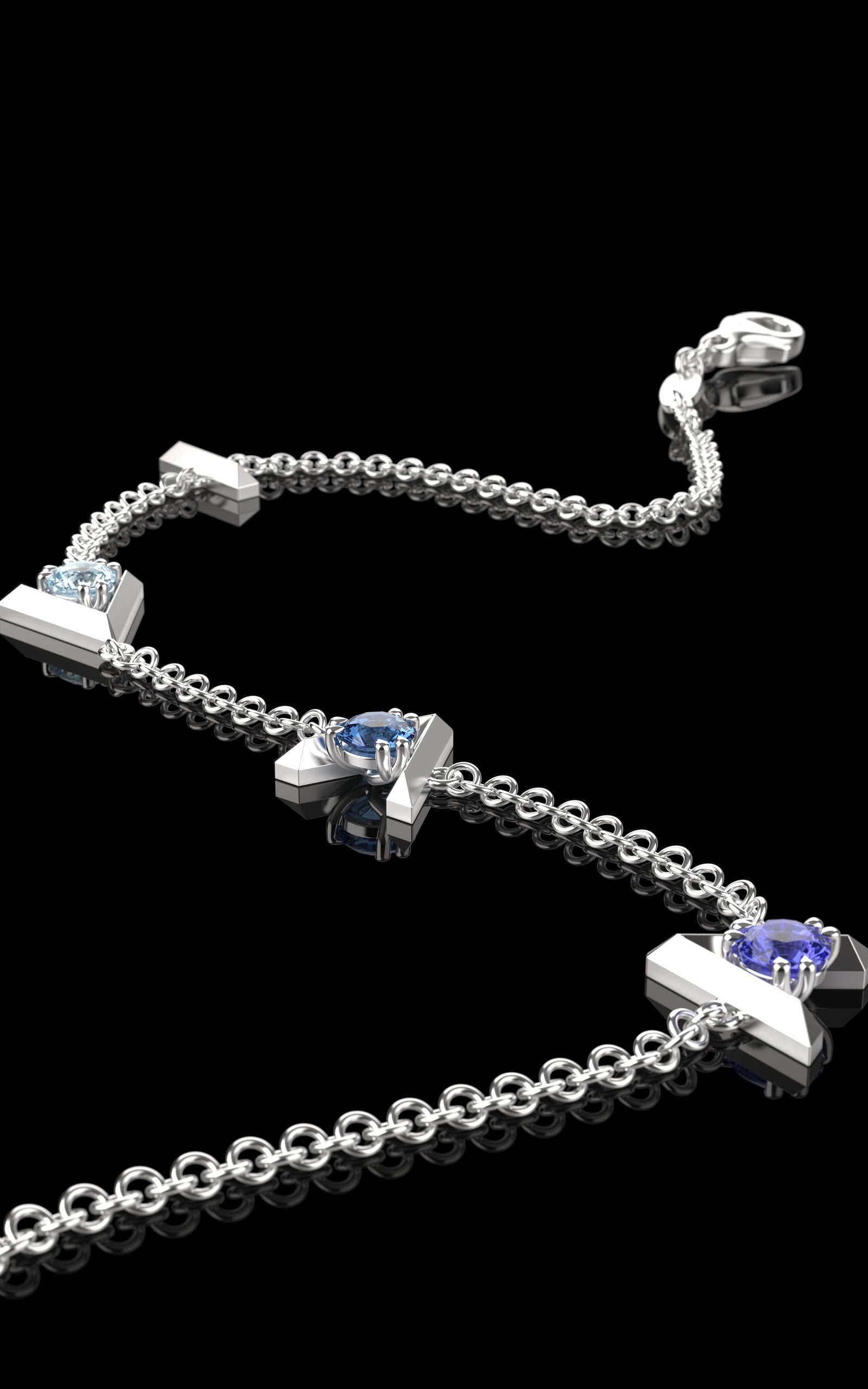 Silver Bracelet with "I am greater than my highs and lows" charms and three different blue gemstones on a black background