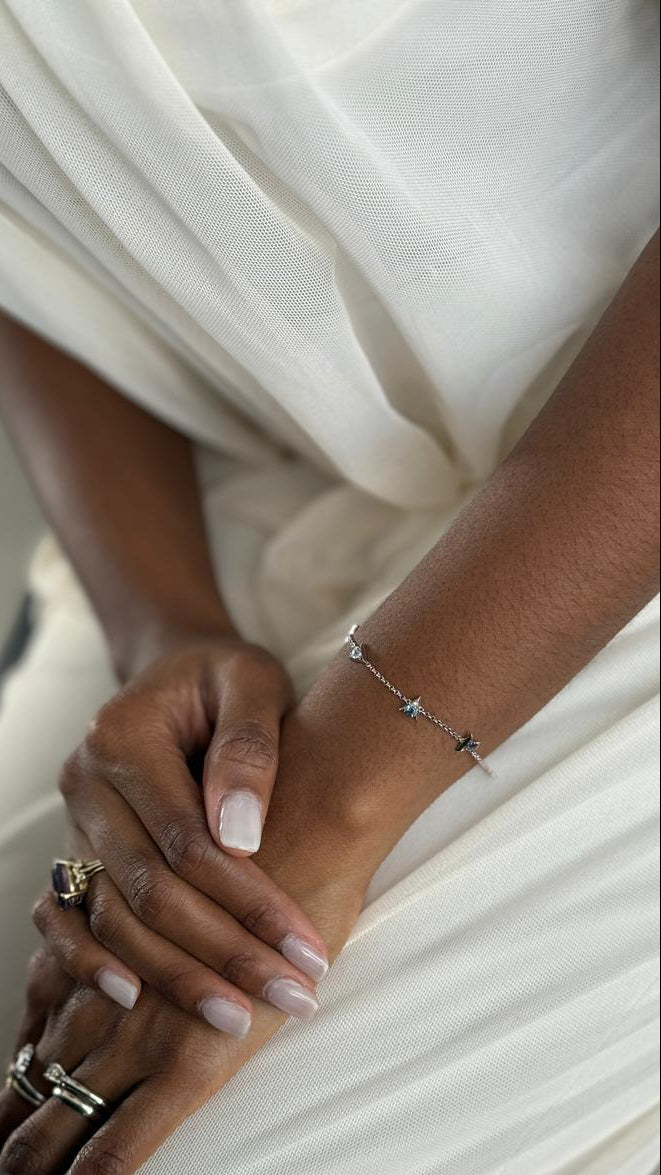Close-up of two hands with jewelry against a white background