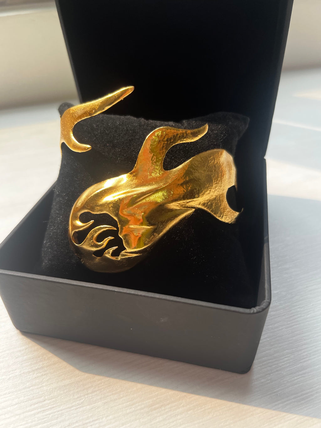 Close-up of the Eleuri Fotia Reimagined Gold CGM armlet in 14K gold with handcrafted finish