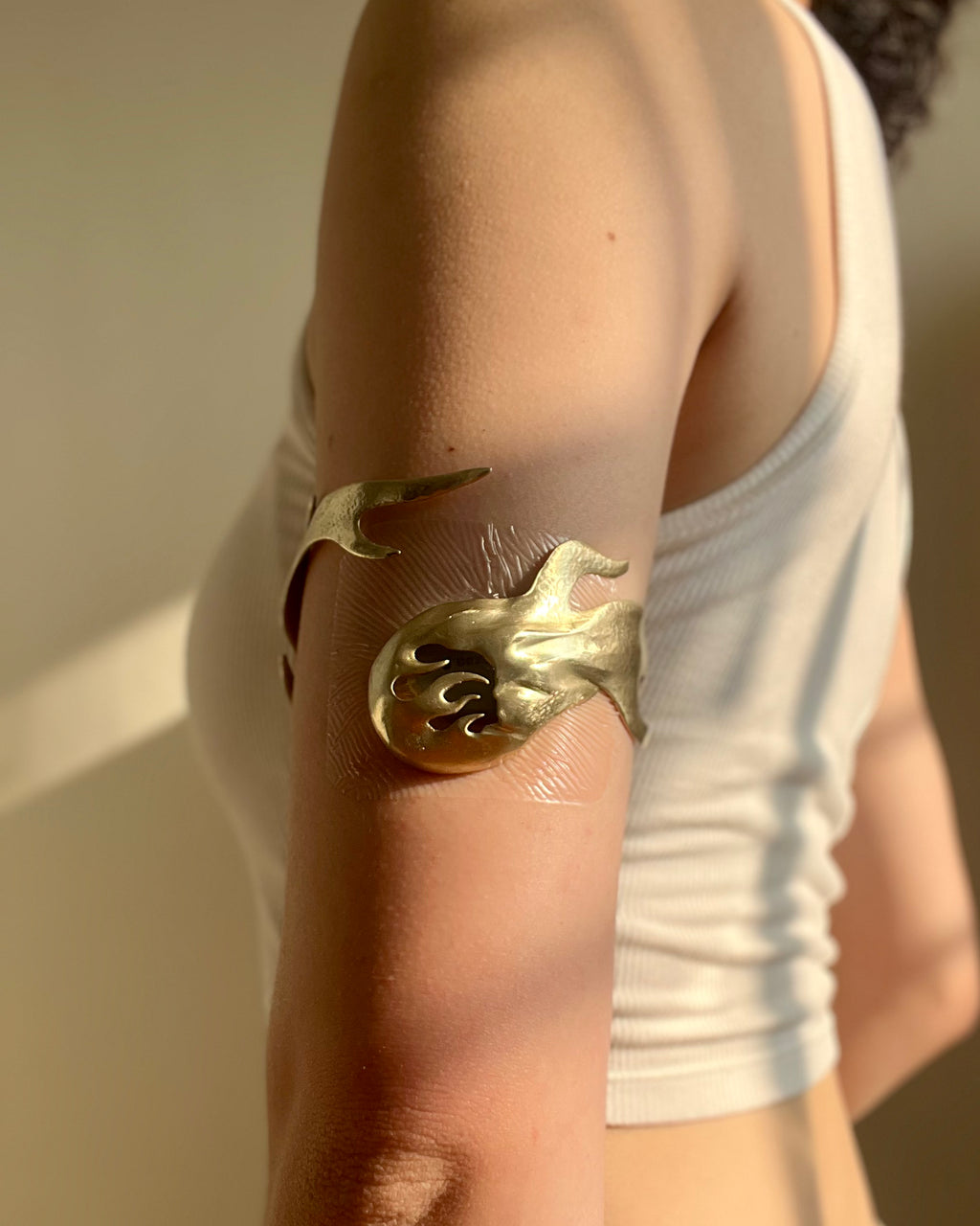 Eleuri Fotia Reimagined Gold CGM armlet worn on upper arm compatible with Dexcom G7