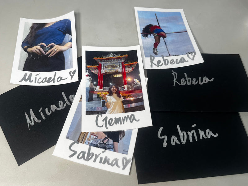 Photos printed on cards with names written on it, black envelopes written with names