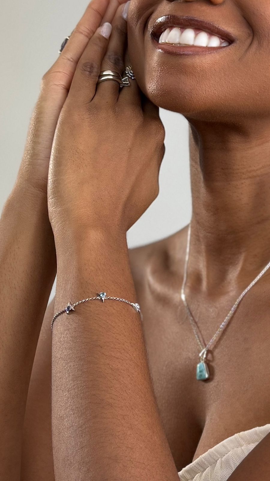woman wearing hi&lo signature bracelet sterling silver with blue topaz and iolite on her wrist